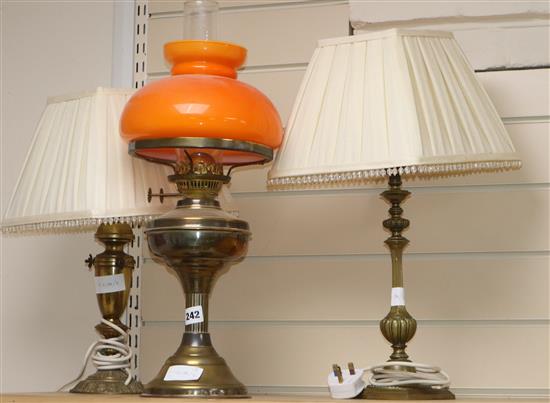 A brass oil lamp and two table lamps